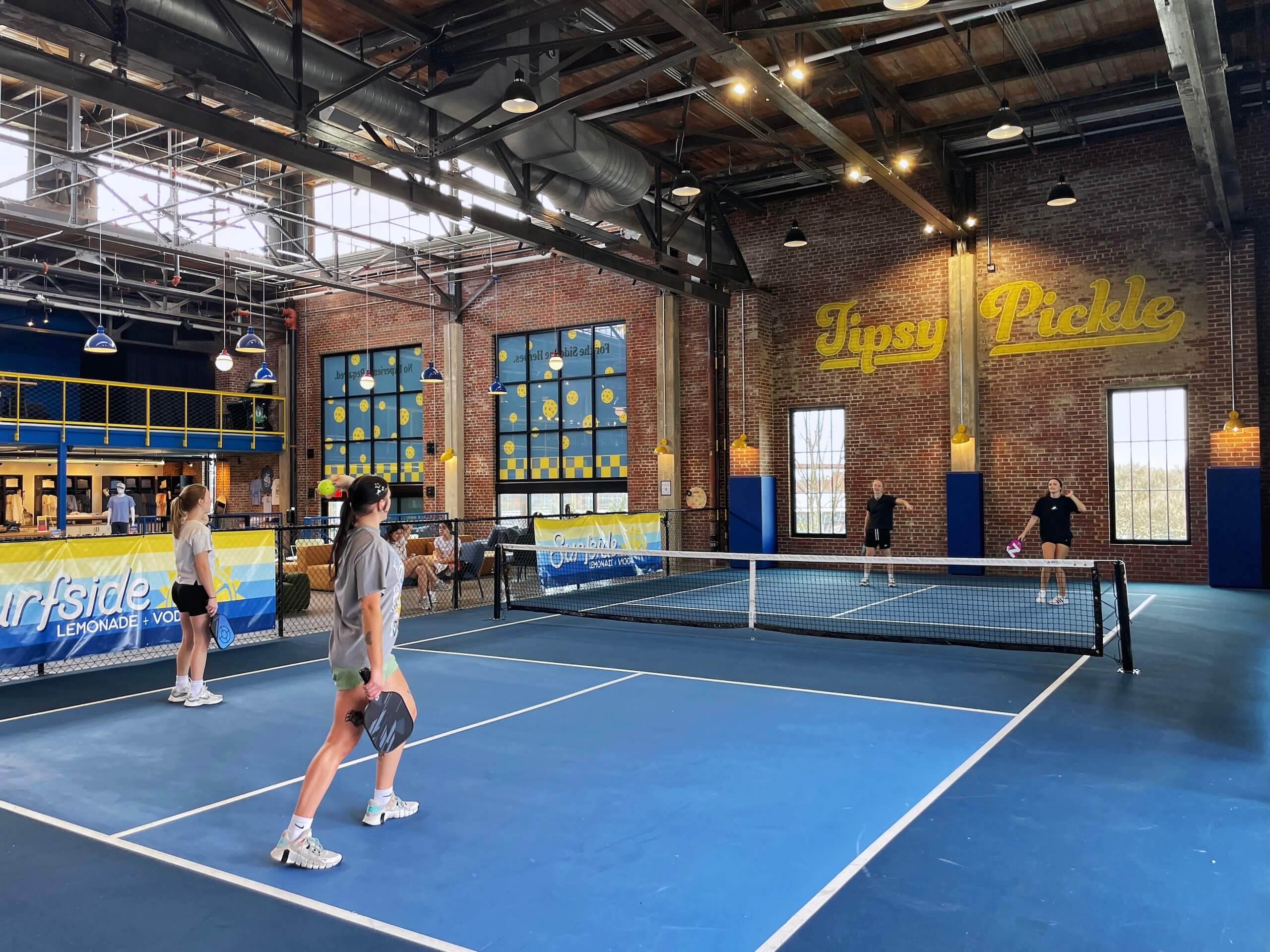 People playing pickleball indoors at Tipsy Pickle in Camp North End Charlotte
