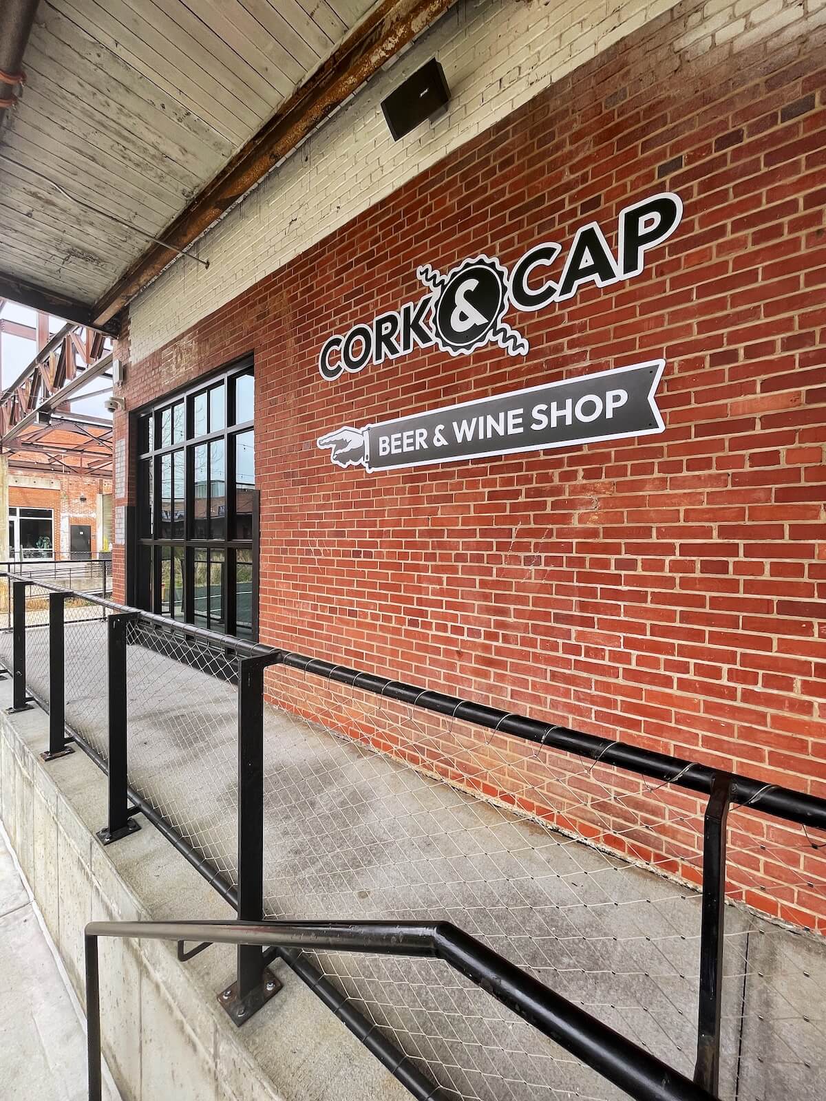 Brick wall with large sign for Cap & Bottle at Camp North End Charlotte