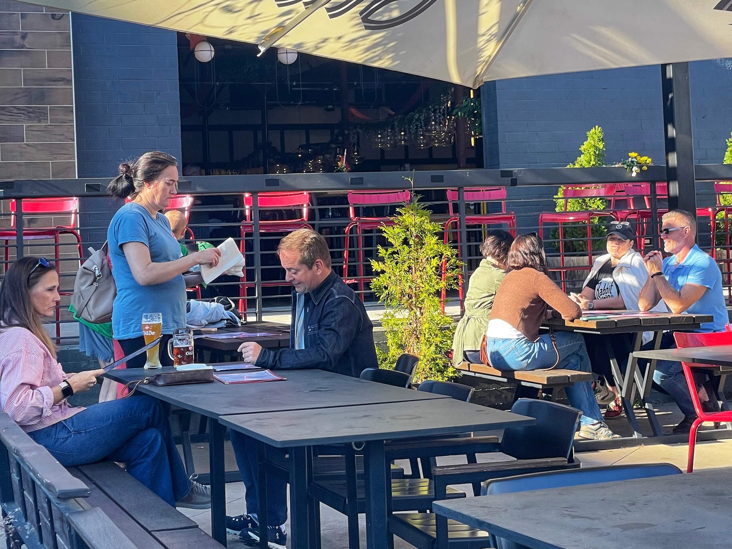 People eating lunch on the Gilde Brewpub patio in LoSo Charlotte