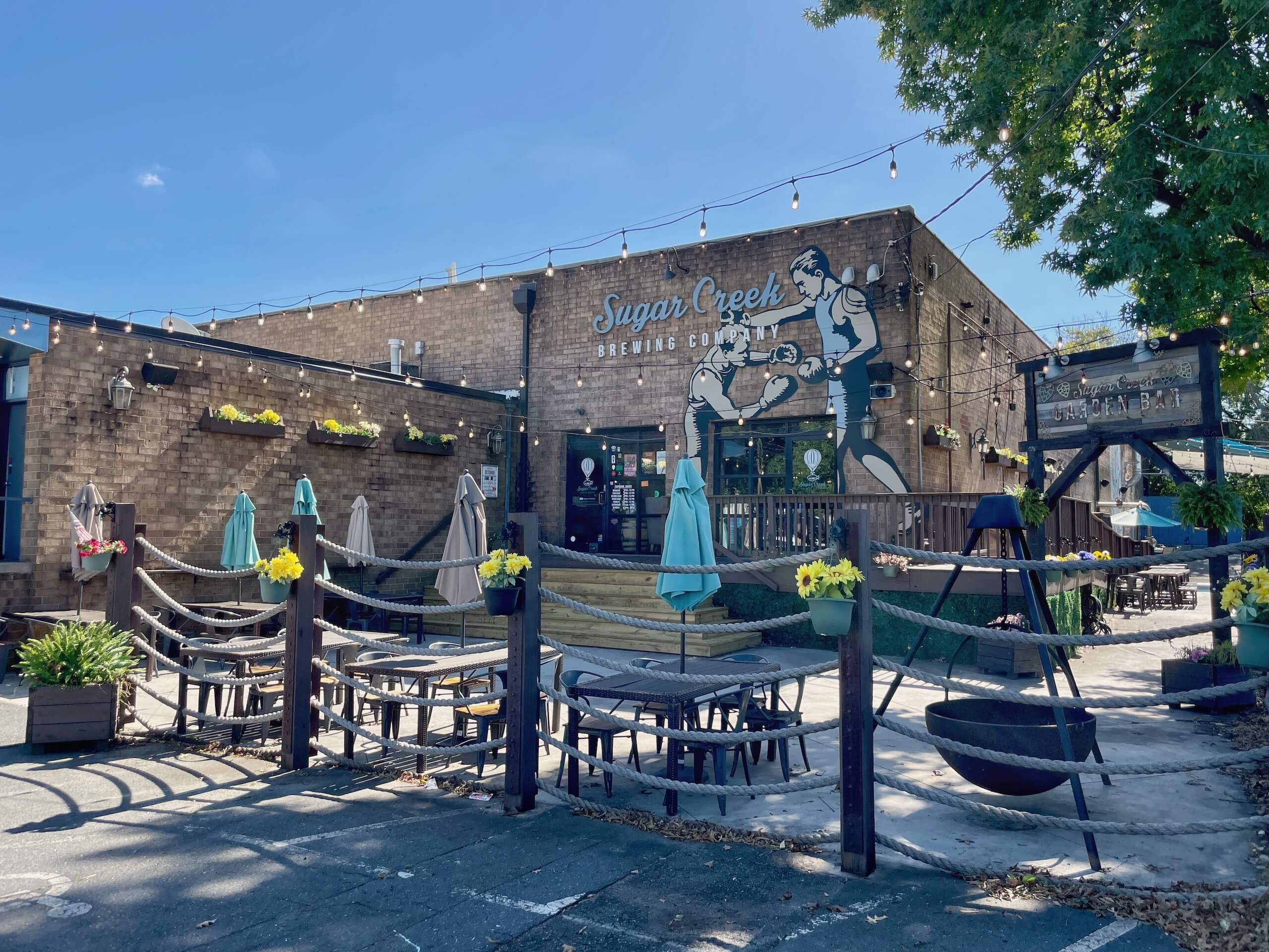 Sugar Creek Brewing Company in LoSo Charlotte front patio on a sunny day
