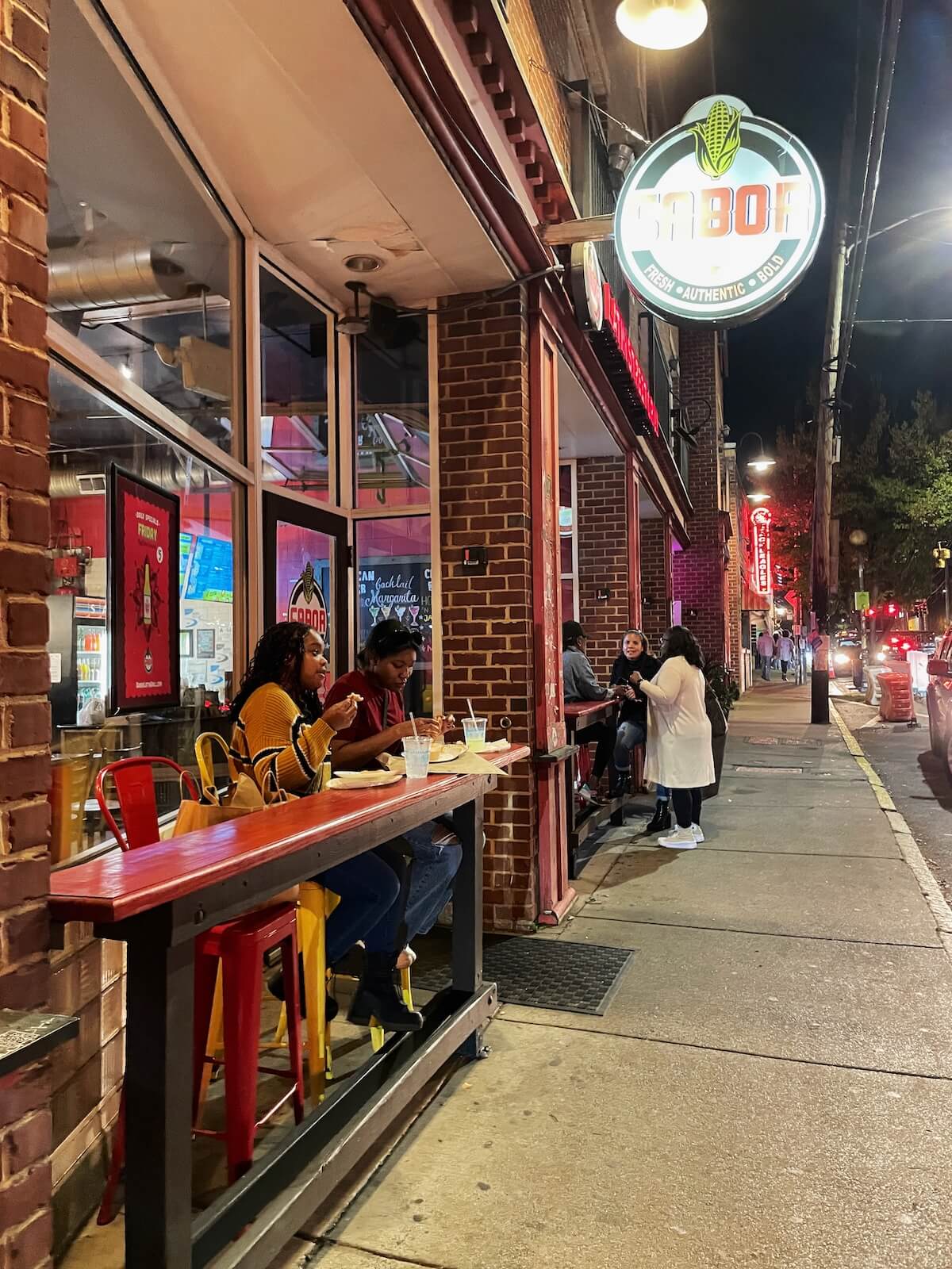 People eating dinner at a patio restaurant in NoDa