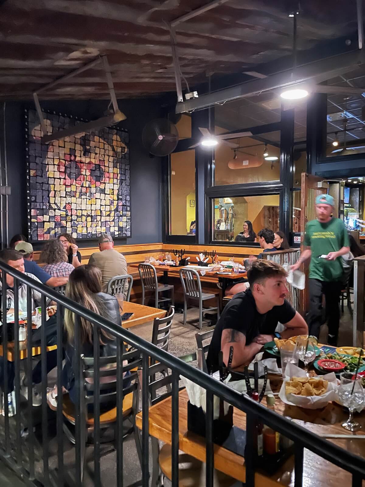 People eating dinner at a patio restaurant in NoDa at night