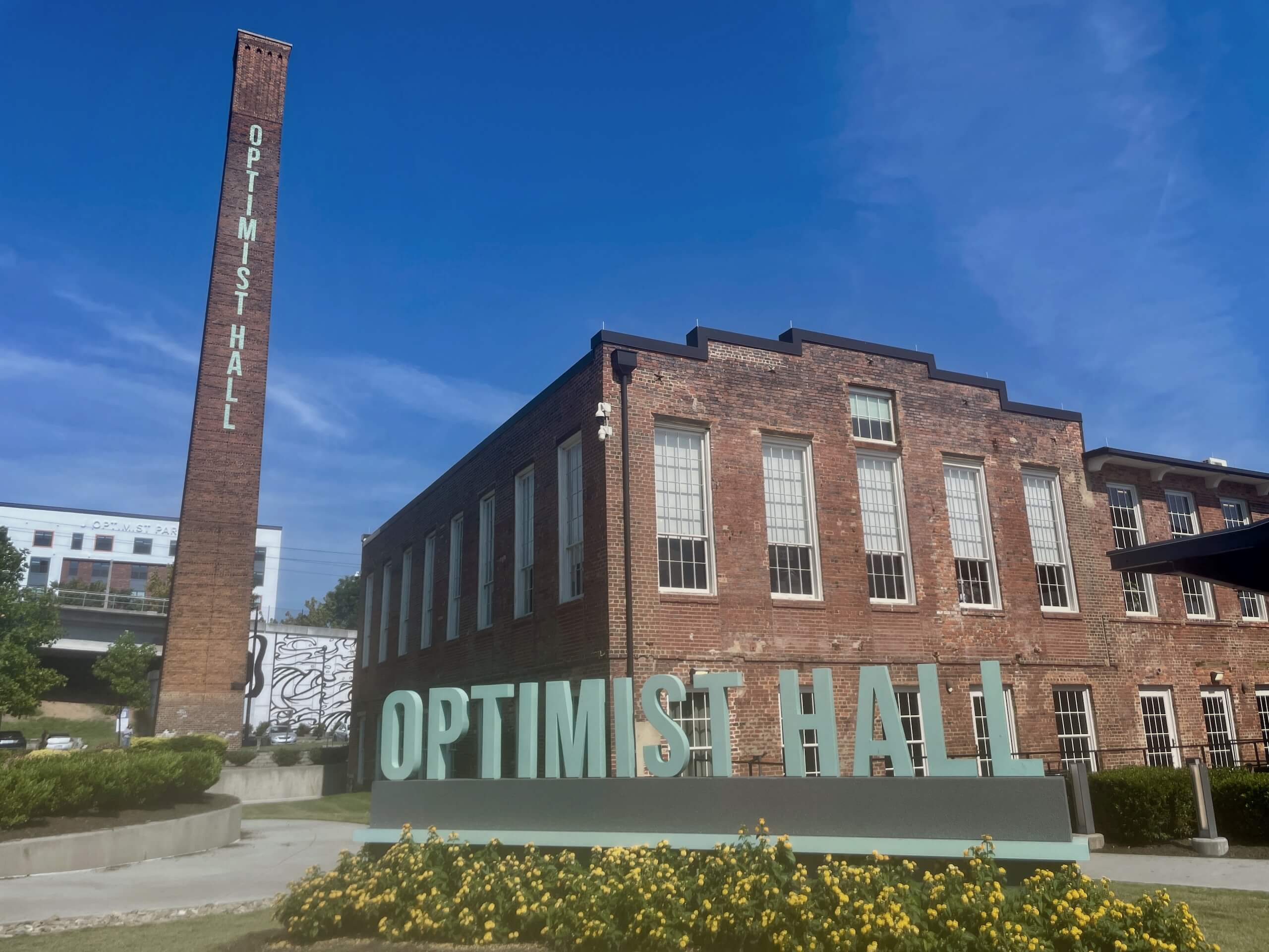 Outside of Optimist Hall food hall in Charlotte on a sunny day