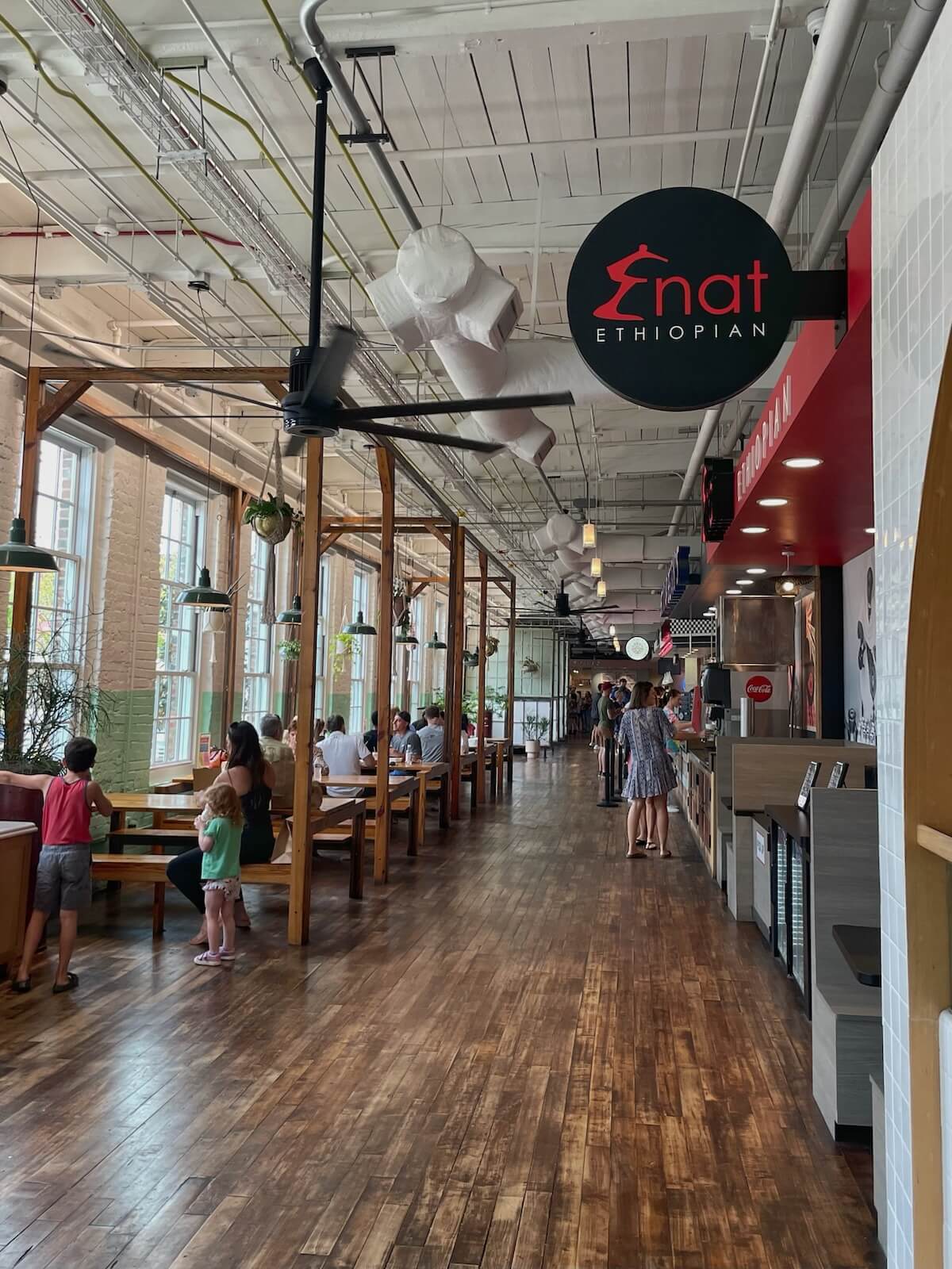 Signage for Enat Ethiopian cuisine in sunny Optimist Hall in Charlotte