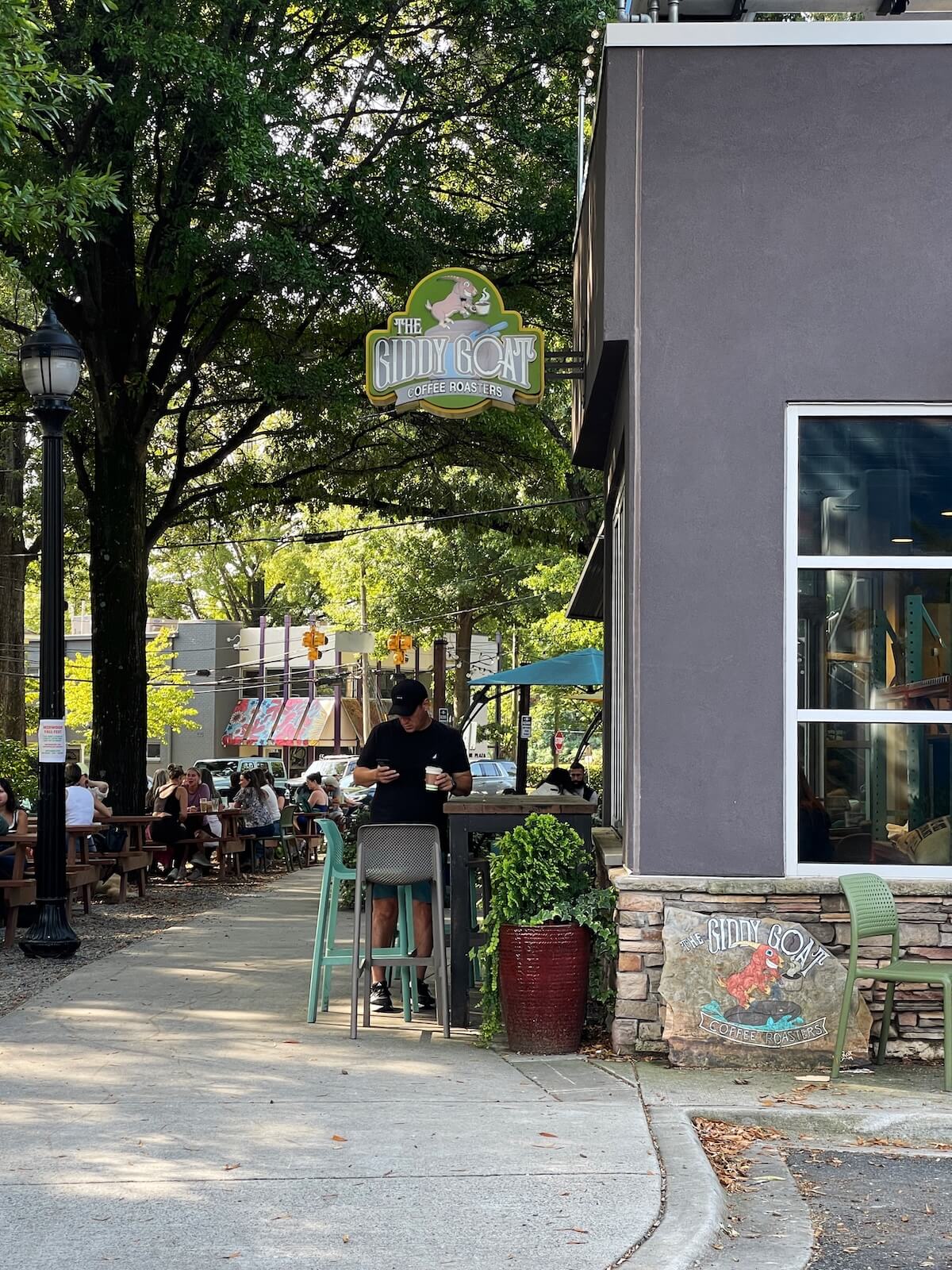 Man standing outside of Giddy Goat Coffee Roasters in Plaza Midwood Charlotte