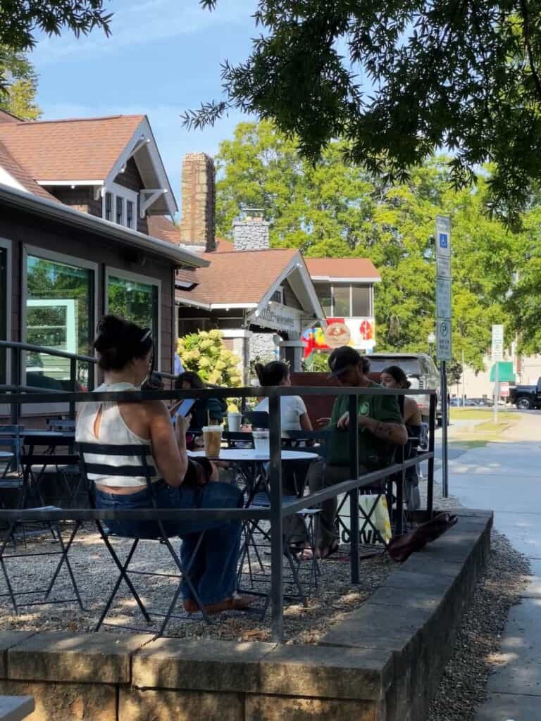 People enjoying coffee outside of a sidewalk cafe in Plaza Midwood, Charlotte
