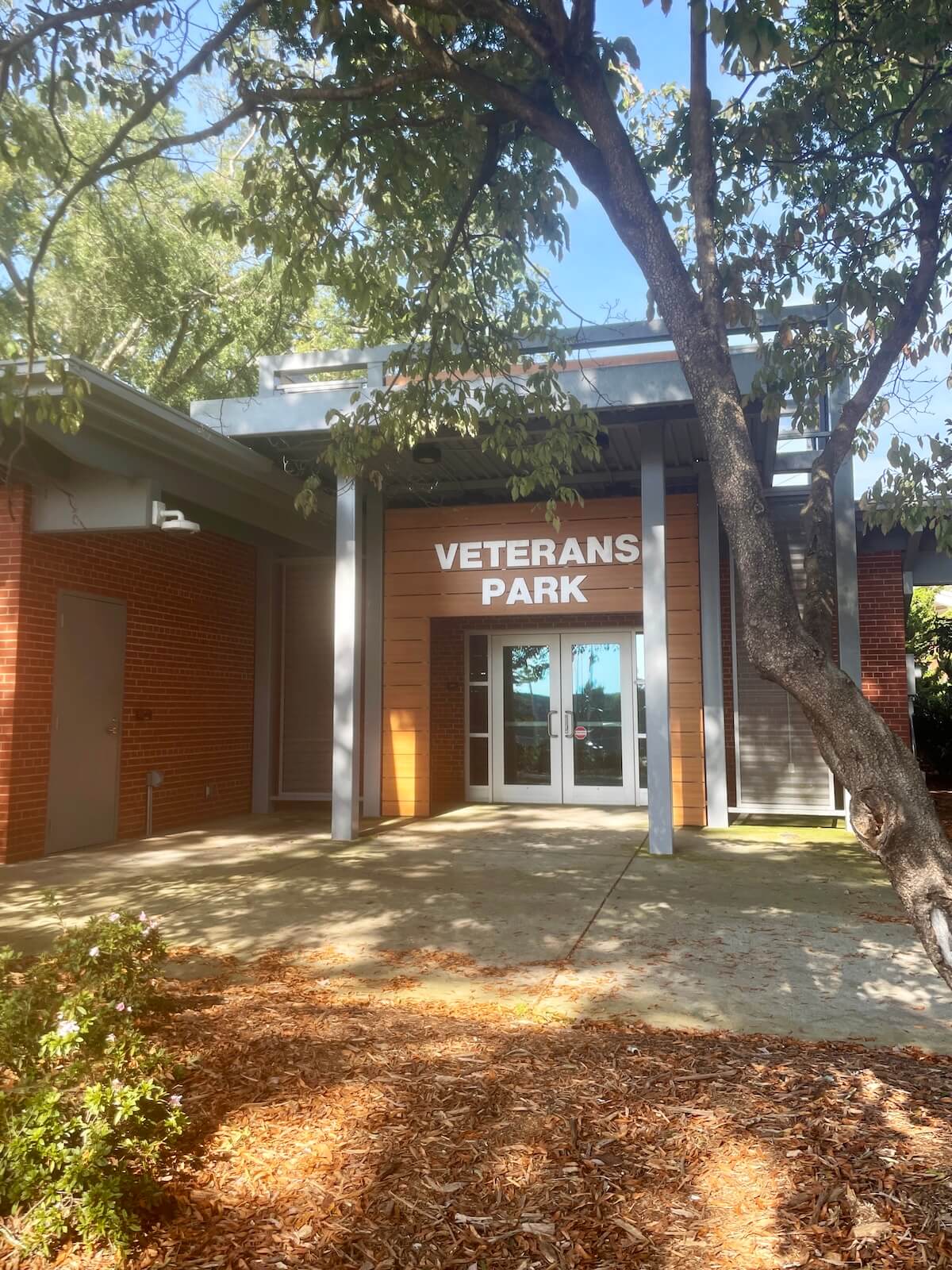 Red brick building with sign that reads Veterans Park