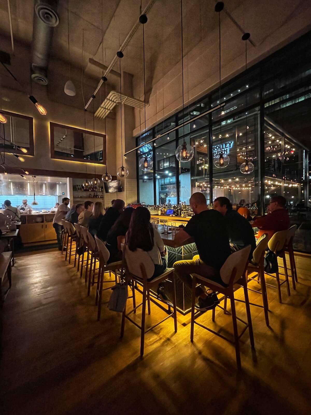 People enjoying drinks at the bar inside Indaco restaurant in Charlotte
