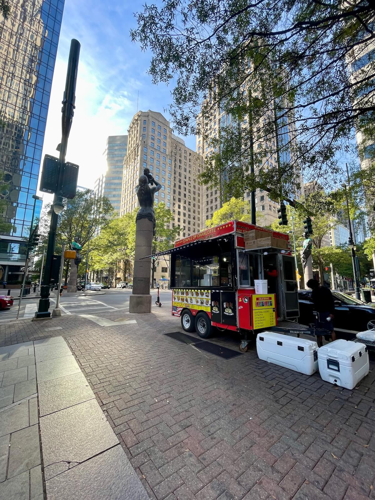Halal Food Cart in Uptown Charlotte with skyscrapers in the background