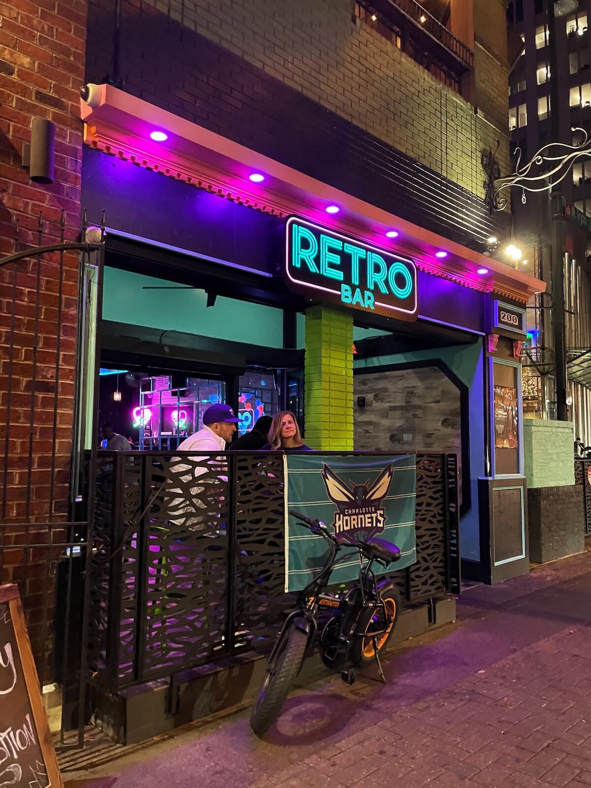 People waiting in line at Retro Bar in Uptown Charlotte at night. 