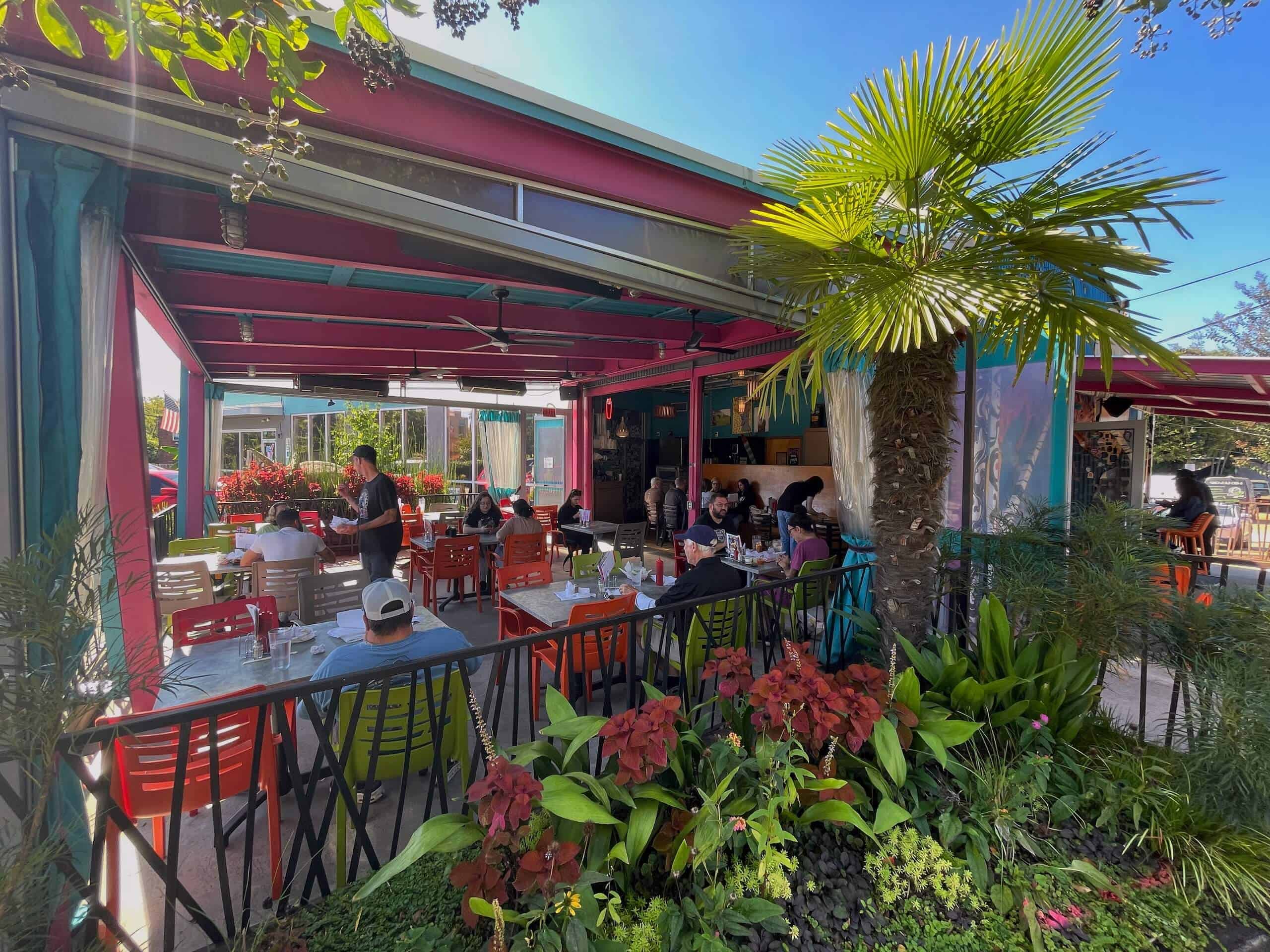 People eating lunch on the patio at Pinky's Westside Grill in Charlotte on a sunny day.