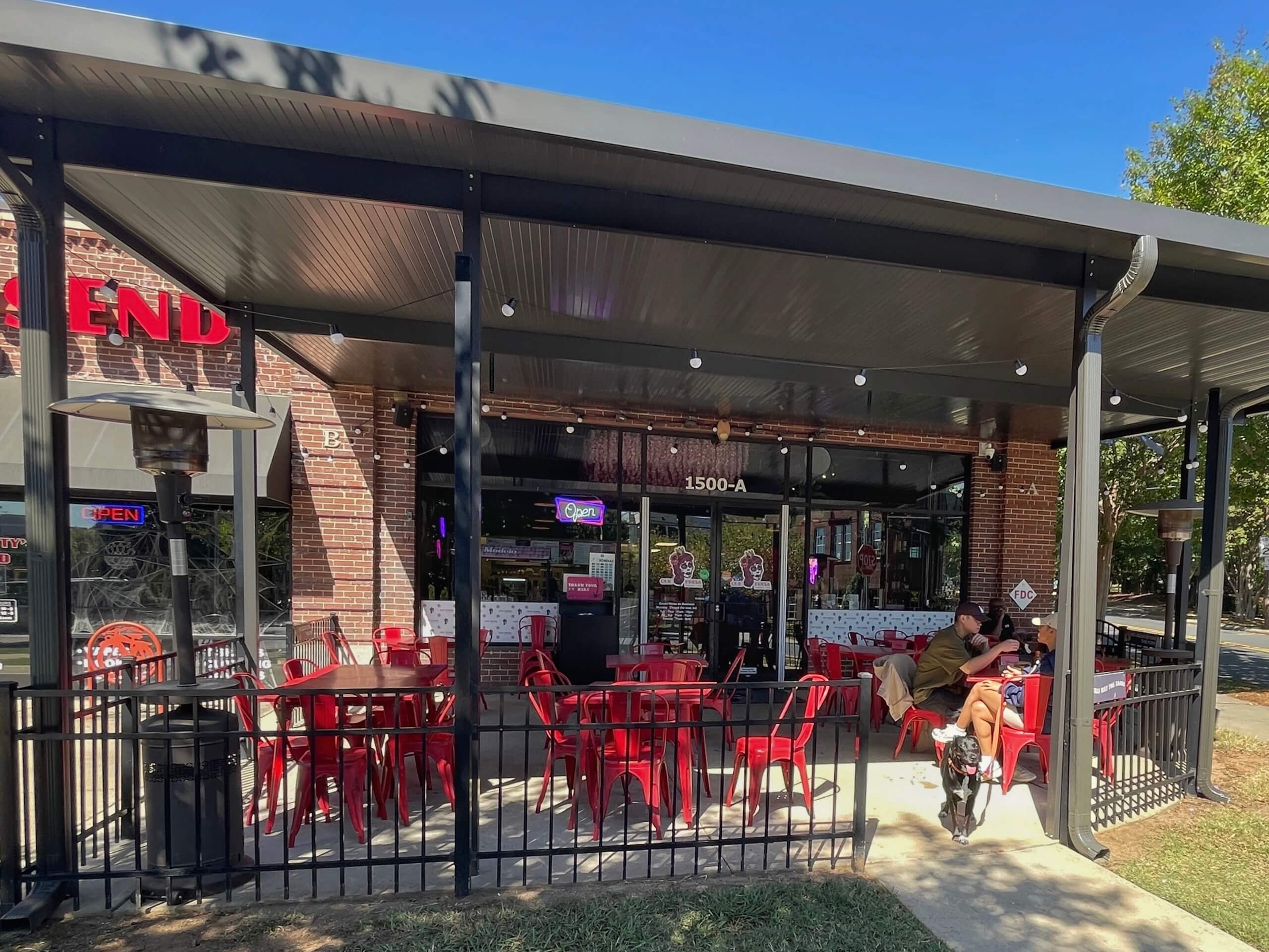 people eating on a restaurant patio in west end charlote