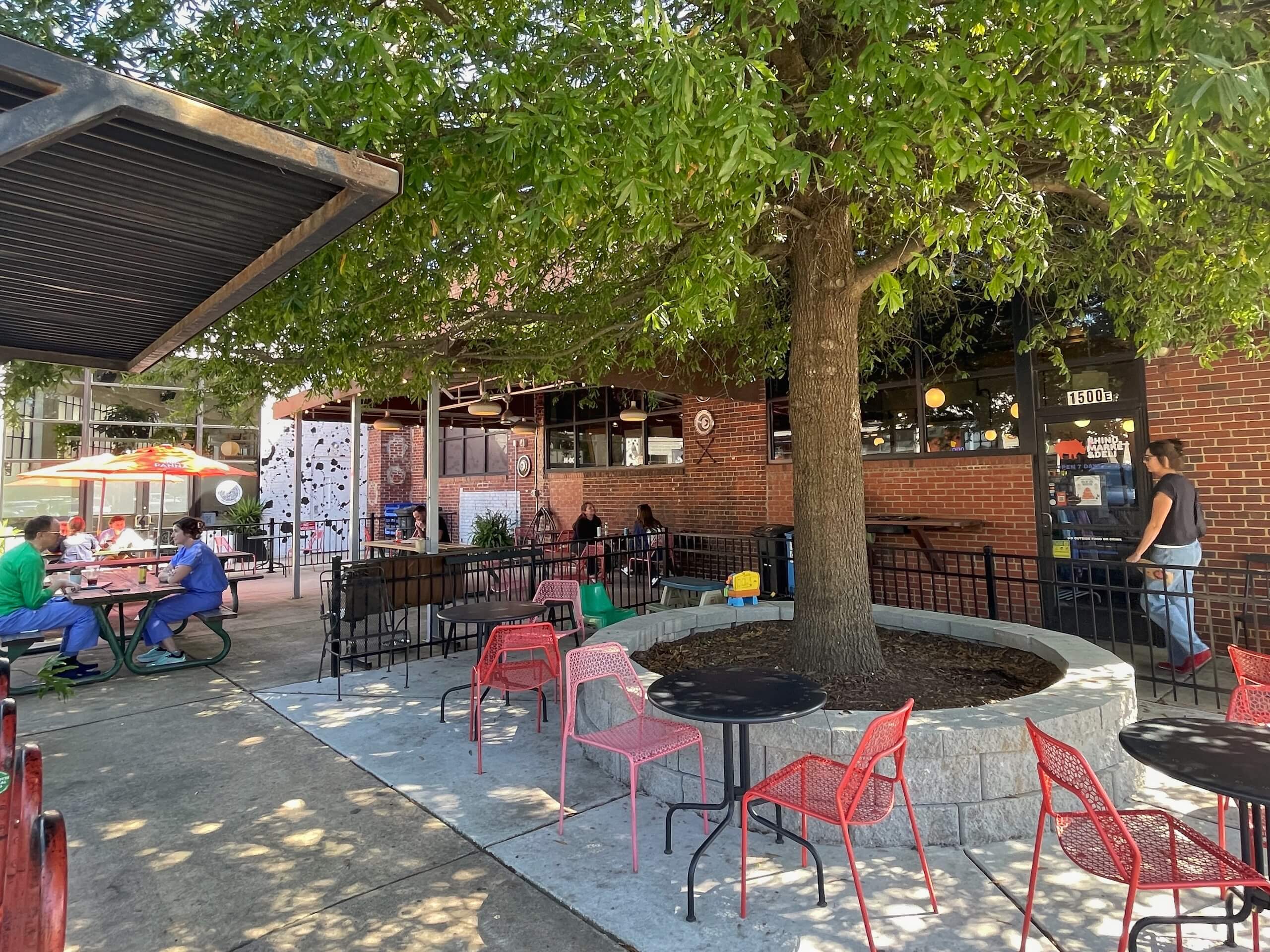 People eating on the patio at Rhino Market and Deli in West End Charlotte
