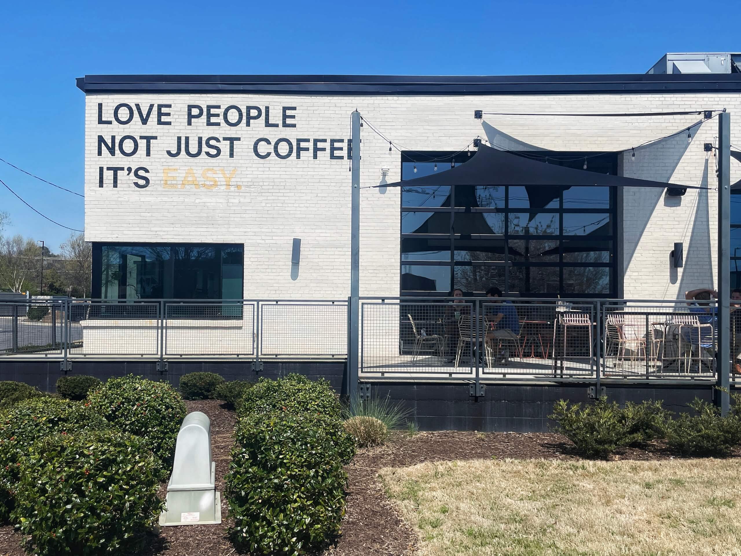 Building inLoSo Charlotte with sign that reads LOVE PEOPLE NOT JUST COFFEE IT'S EASY.
