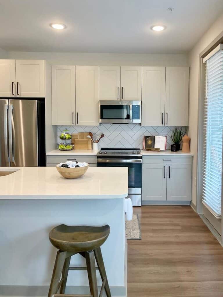 Bright, modern kitchen featuring white cabinets, stainless steel appliances, and ample natural lighting in a 2 bedroom apartment at Axis at the Park in University City, Charlotte.
