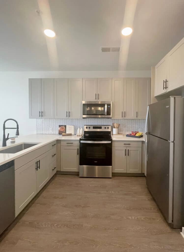 Soft contemporary kitchen with neutral cabinets and stainless steel appliances in a 1 bedroom apartment at Bowery West Charlotte