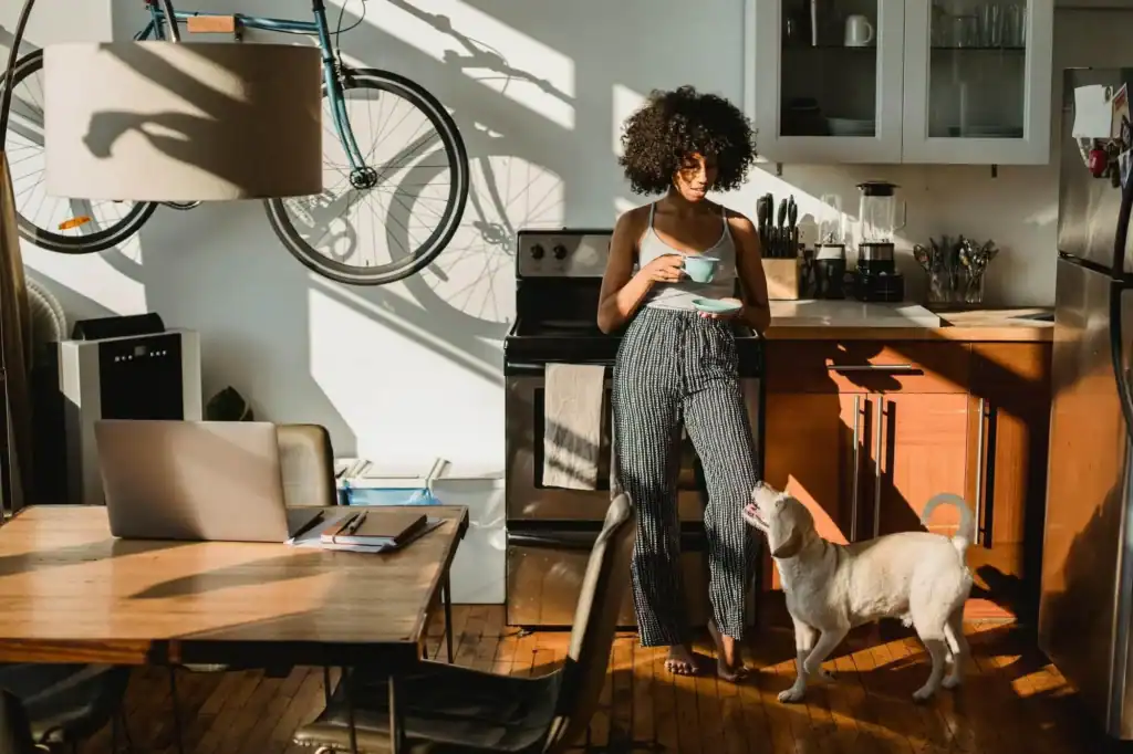 Woman with dog in stylish kitchen, urban living space.